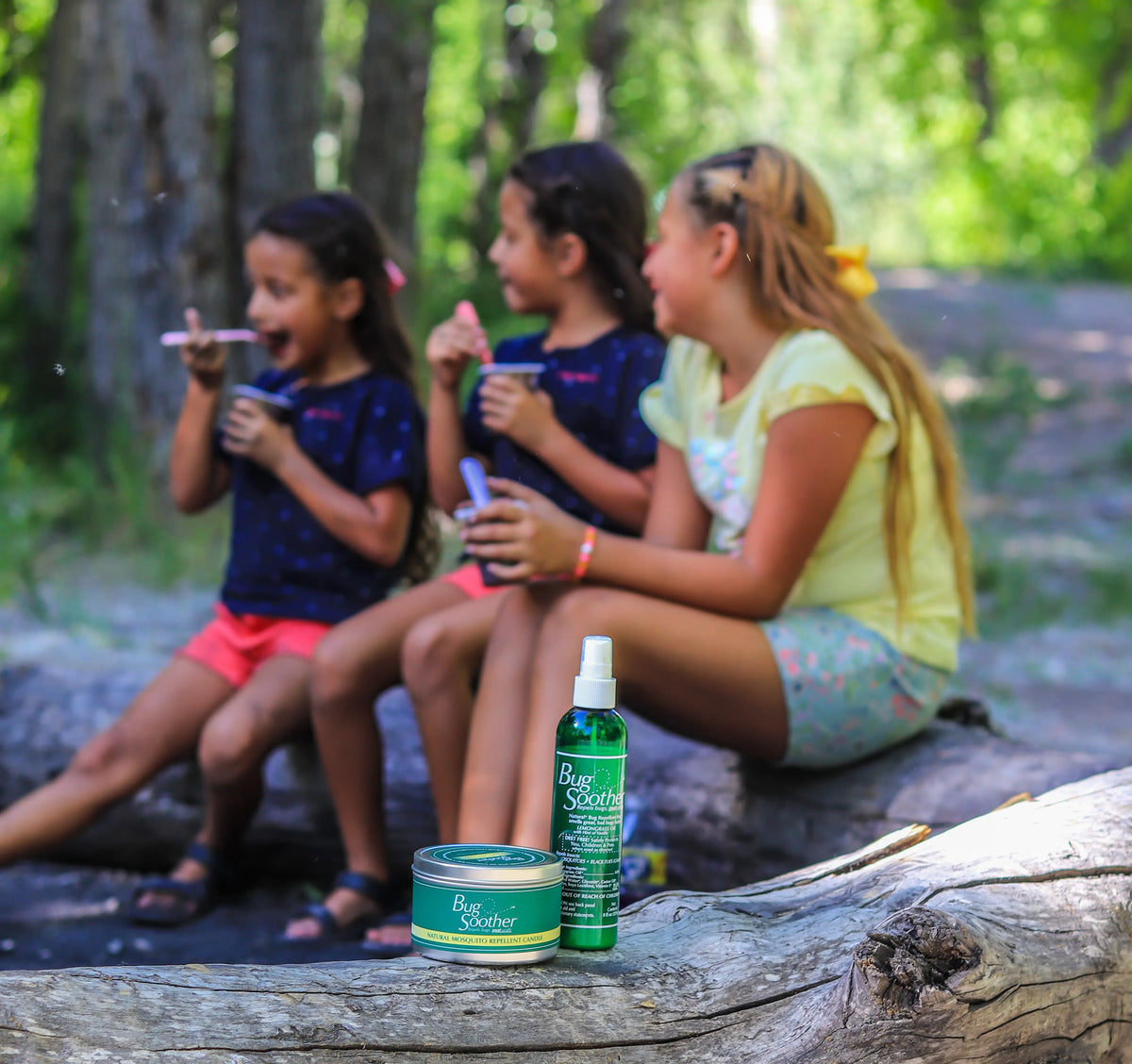 Advertisement of Bug Soother and candle outdoors with children. 