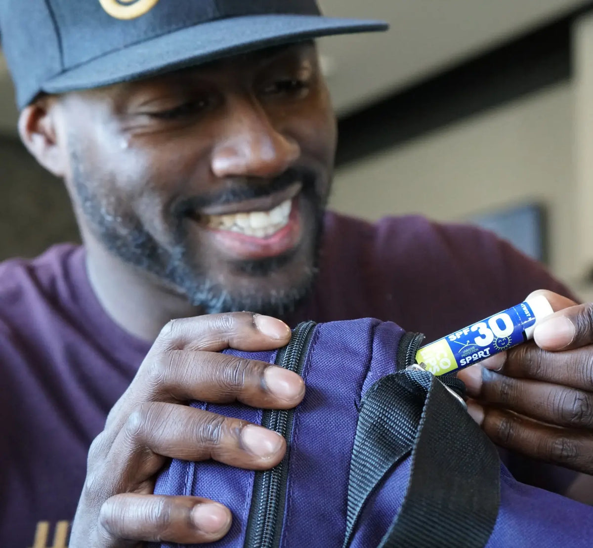 A man holding a SPF 30 lip balm.